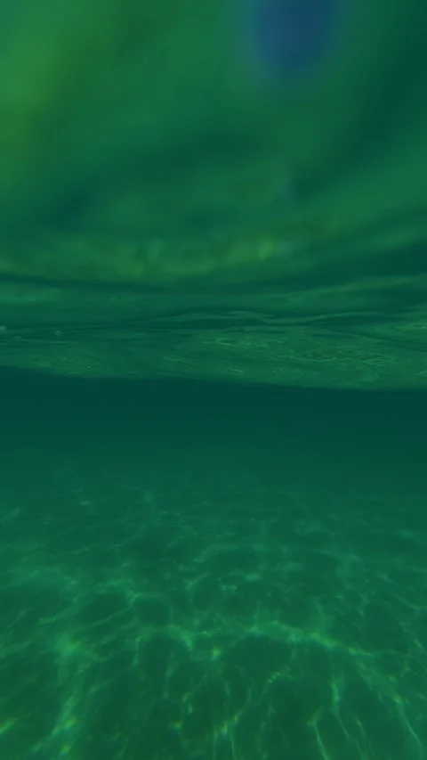 Crystal waters ripple under a vast, clear sky. Trani Ammouda, Greece. Vertical Stock Footage 338357909