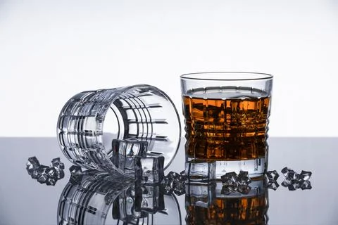 Crystal whiskey glasses on a reflective surface Stock Photos