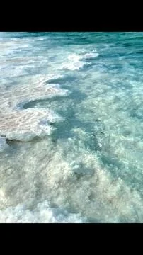Crystallized salt formation edges dissolve into clear water, with light Foto stock