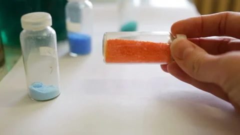 Crystals of potassium dichromate (K2Cr2O7) in a glass vial. Close-up, real time, Video stock 85612679