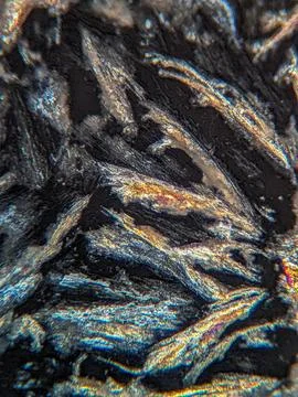 Crystals under polarized microscope showing subtle color fringe 스톡 사진