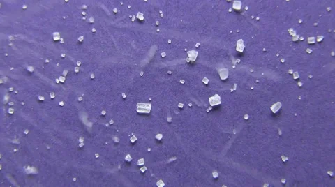 Crystals of white sugar being poured on a blue background Stock Footage 59853328