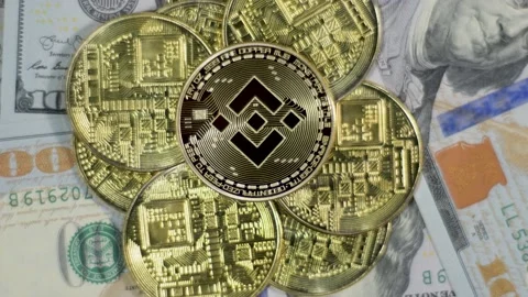 Crytocurrency Exchange BINANCE and DOLLAR bills, BNB to USD, coin close up Stock Footage 196798129