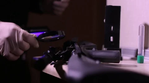 CSI Expert at crime scene exploring rifle Stock Footage