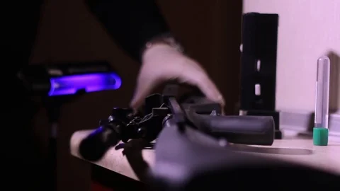 CSI Expert at crime scene exploring rifle Stock Footage 73258343