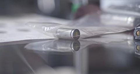 CSI expert examining weapon bullet closeup Stock Footage 106460389