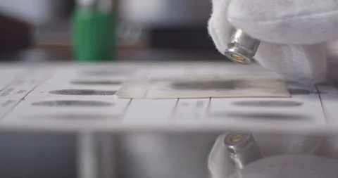 CSI expert examining weapon Stock Footage 106460423