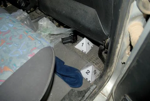 CSI visual inspection inside a car found a firearm, a pistol Stock Photos