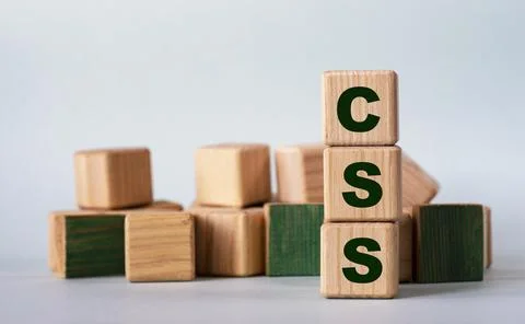 CSS - acronym on wooden cubes on a background of colored block on a light bac Stock Photos