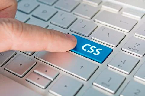 CSS computer language. writing on button modern of gray laptop. Finger presse 스톡 사진
