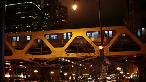 CTA Train passing over River on Elevated Track at Night. Train cars illuminated 스톡 동영상 172220381