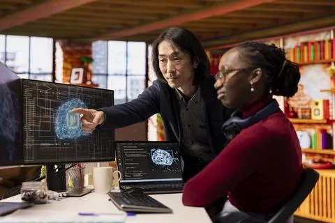 CTO manager overseeing work done by admin in AI tech agency Foto stock