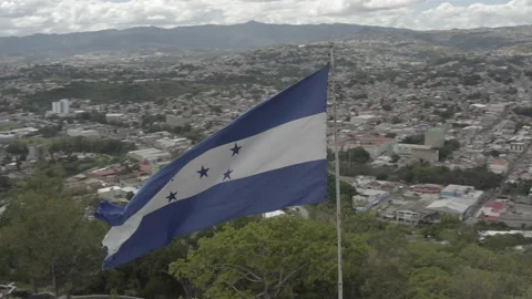 CU aerial circles quickly around waving flag of Honduras 스톡 동영상 166482106
