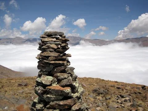 CU Apacheta stone cairn with clouds in mid-background Stock Photos