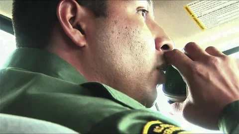 CU Border Patrol Agent On Two-way Stock Footage 209996034