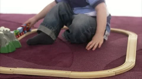 CU Boy (4-5) playing with miniature train Stock Footage 11339592