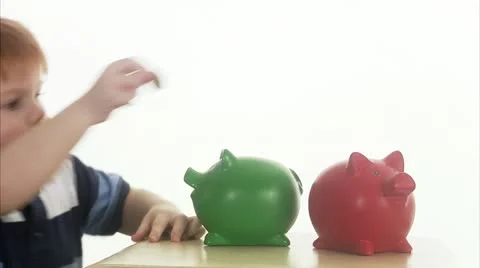 CU Boy (4-5) with two piggy banks Stock Footage 11339618