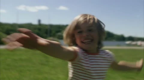 CU Boy running in park Stock Footage 11347145