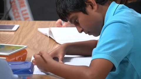 CU boy student working Stock Footage 99375170