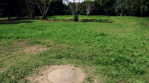 Cu buried sphere tilt up to ws of mounds and Finca 6 village Stock Footage 206502145