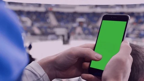 CU Caucasian male using his phone in large sports venue. Green screen Stock Footage 71849007
