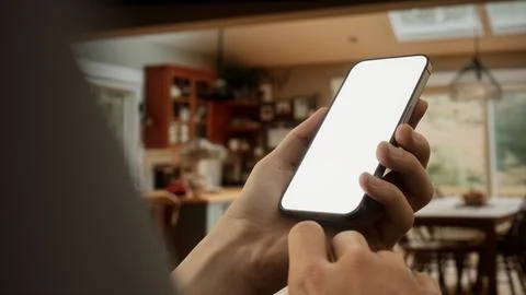 CU Caucasian man using his phone at home Stock Photos