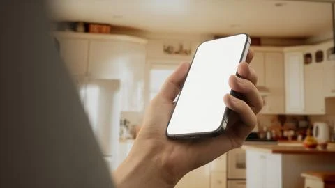 CU Caucasian man using his phone at home Foto stock