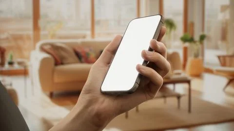 CU Caucasian man using his phone at home Stock Photos