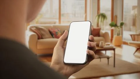 CU Caucasian man using his phone at home Foto stock