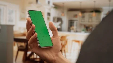 CU Caucasian man using his phone at home Foto stock