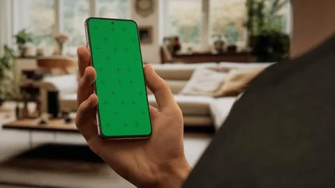 CU Caucasian man using his phone at home Foto stock