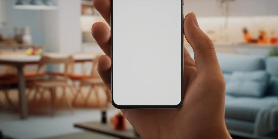 CU Caucasian man using his phone at home, daytime shot 스톡 사진