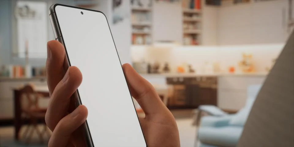 CU Caucasian man using his phone at home, daytime shot Stock Photos