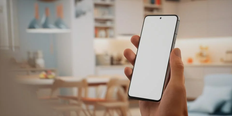 CU Caucasian man using his phone at home, daytime shot Foto stock