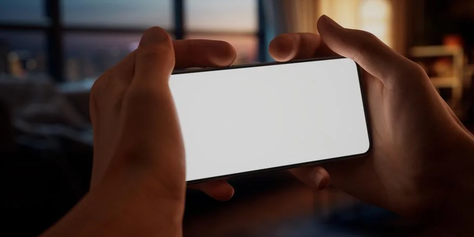 CU Caucasian man using his phone at home, daytime shot 写真素材