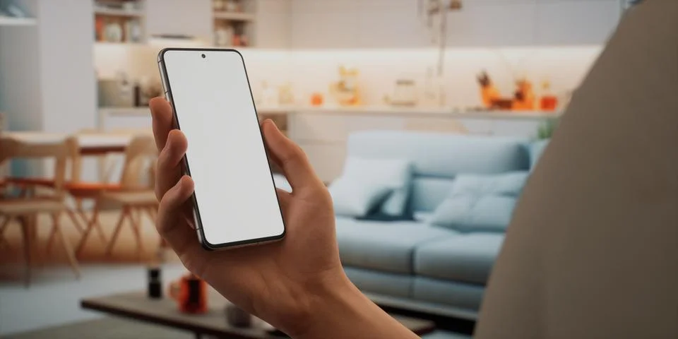CU Caucasian man using his phone at home, daytime shot Foto stock