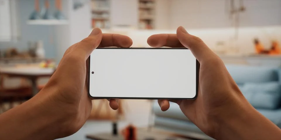 CU Caucasian man using his phone at home, daytime shot 스톡 사진