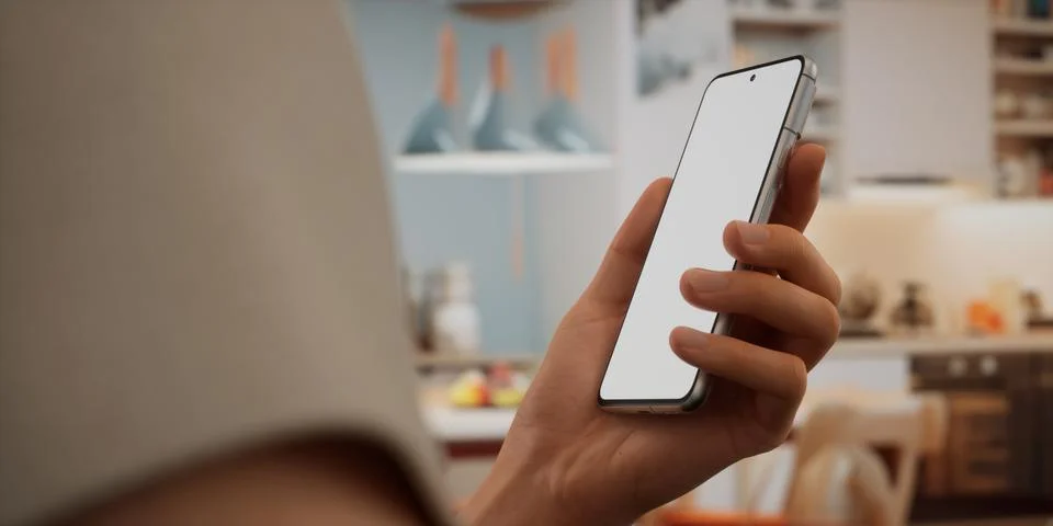 CU Caucasian man using his phone at home, daytime shot Stock Photos