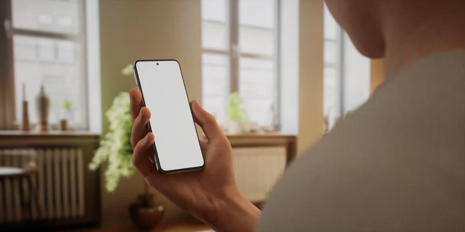 CU Caucasian man using his phone at home, daytime shot Foto stock