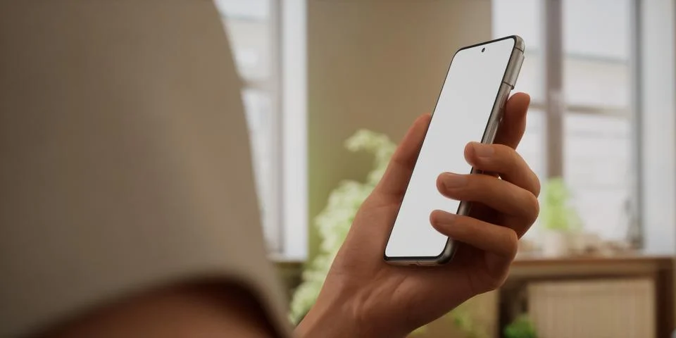 CU Caucasian man using his phone at home, daytime shot Stock Photos