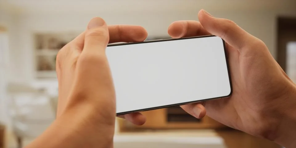 CU Caucasian man using his phone at home, daytime shot Foto stock