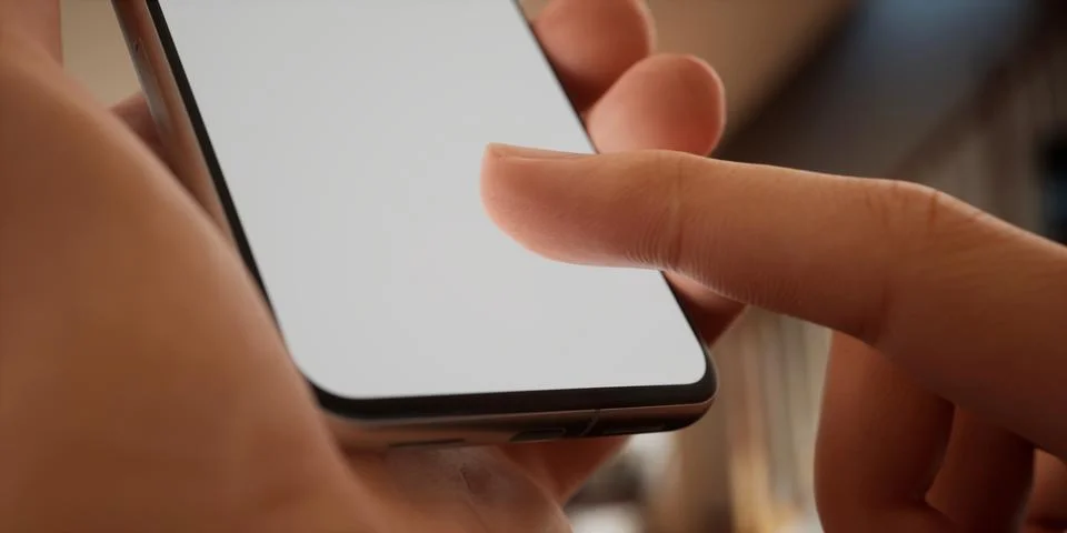 CU Caucasian man using his phone at home, daytime shot Foto stock