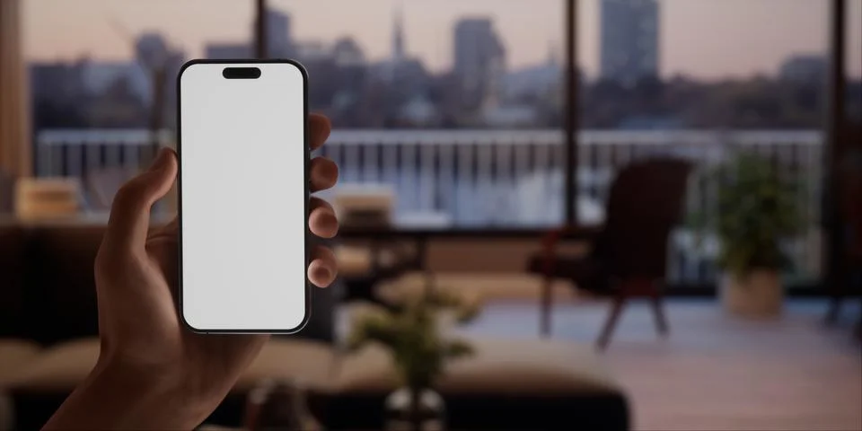 CU Caucasian man using his phone at home, evening shot Foto stock