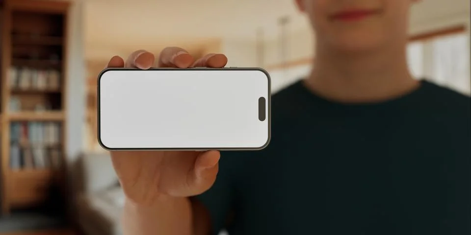 CU Caucasian man using his phone at home, daytime shot Foto stock