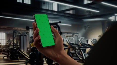 CU Caucasian man using phone in a gym, coaching training sports app mockup Stock Footage 255129344
