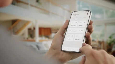 CU Caucasian man using smart home application on his phone 写真素材