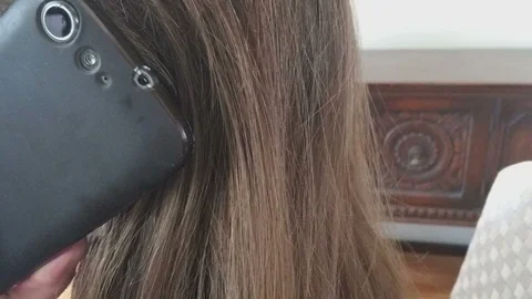 CU of Cellphone Held to Ear Head Nodding then Shaking "no" Then Cellular Lowered Видео 87029407