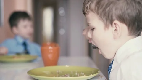 CU: Children have breakfast before they go to school Stock Footage 105097003