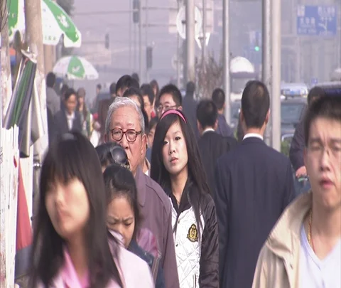 CU Chinese pedestrians walk towards camera on crowded street. Stock Footage 86743580