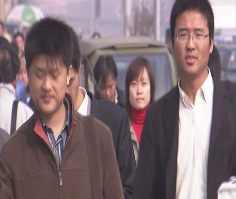 CU Chinese pedestrians walk towards camera on crowded street. Vehicle visible. Stock Footage 86743589